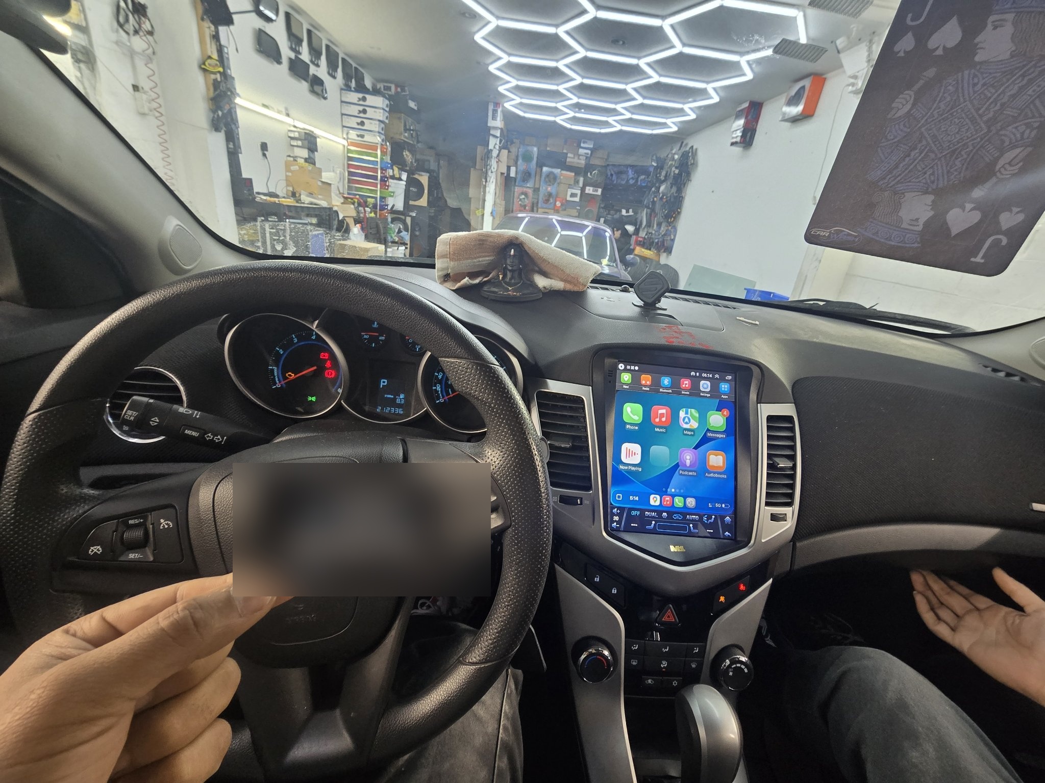 2011 Chevy Cruze dashboard with a new touchscreen head unit showing CarPlay