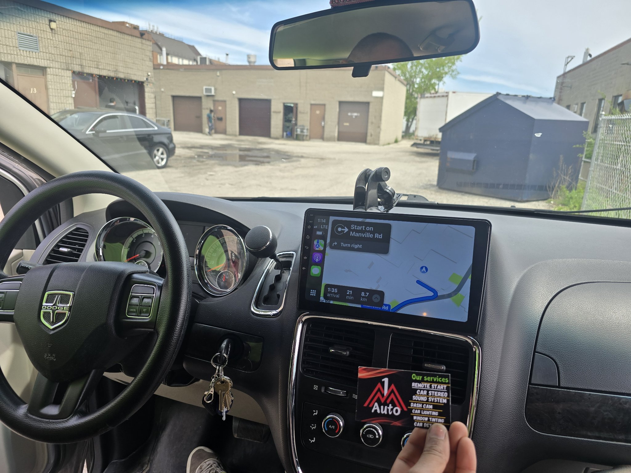 2013 Dodge Caravan dashboard with a new touchscreen head unit showing maps