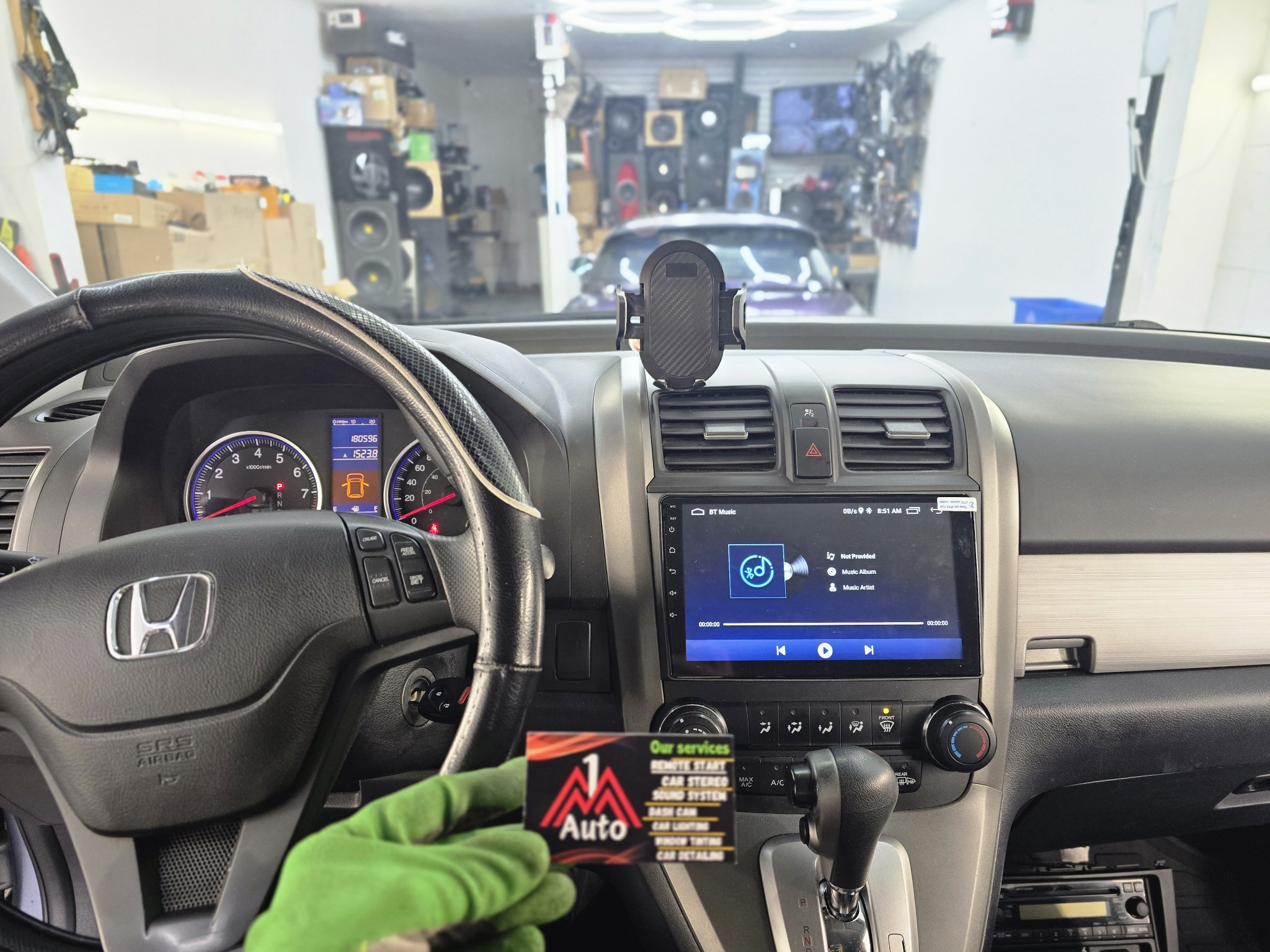 2009 Honda CR-V dashboard with a new touchscreen head unit showing Bluetooth music