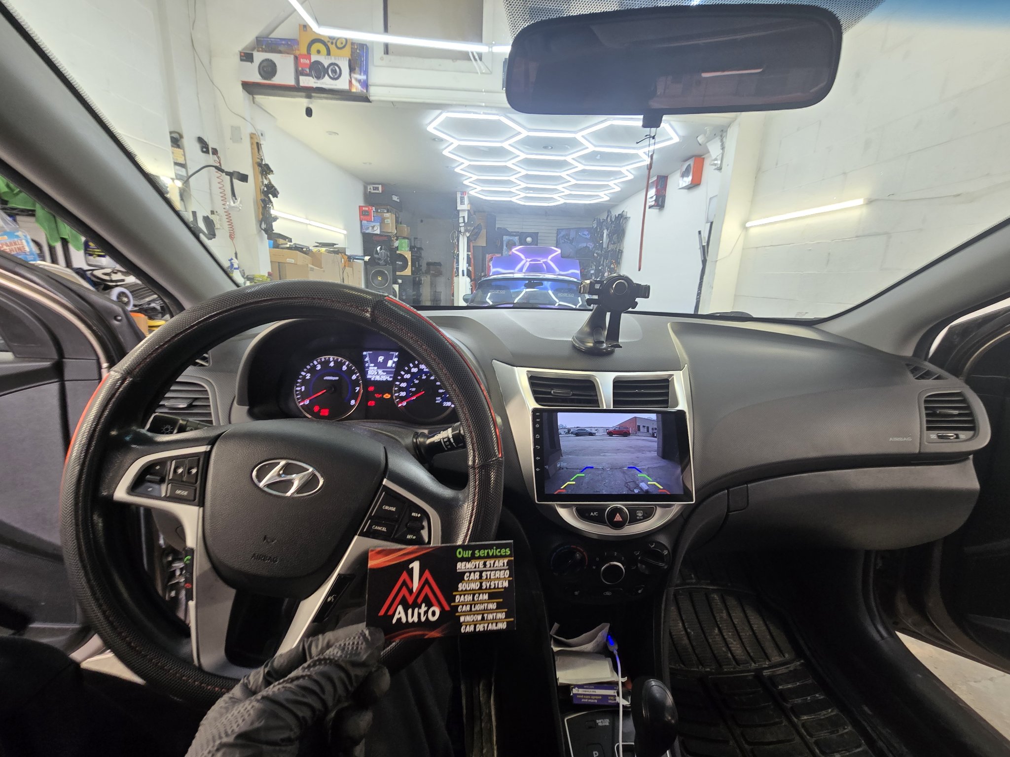 2012 Hyundai Accent dashboard with a new touchscreen head unit showing the backup camera