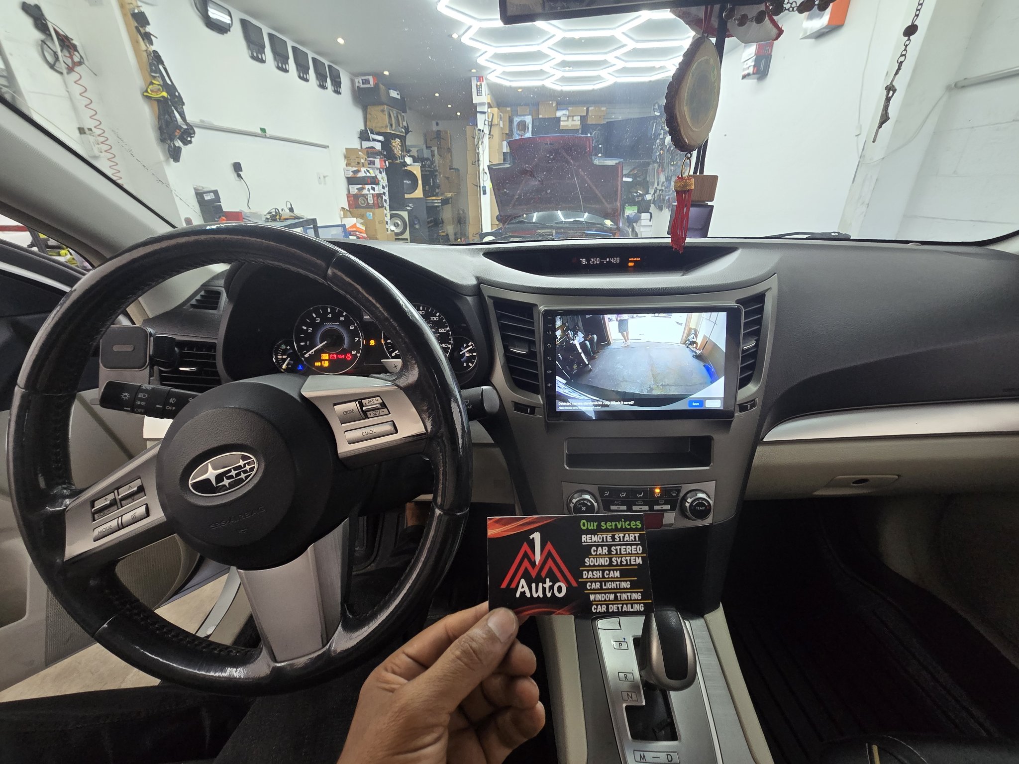 2012 Subaru Outback dashboard with a new touchscreen head unit showing the backup camera
