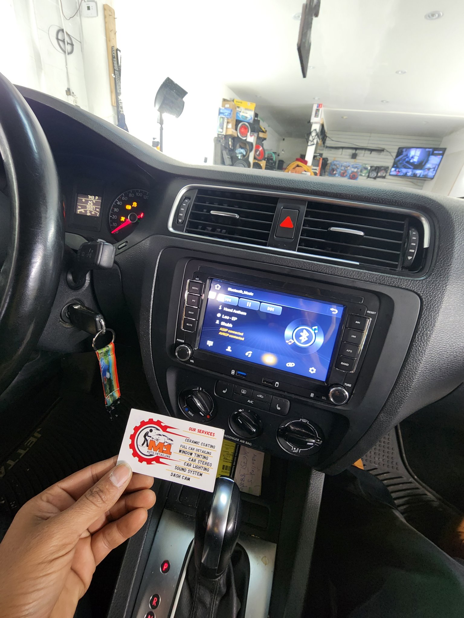 2013 Volkswagen Jetta dashboard with a new touchscreen head unit showing Bluetooth music